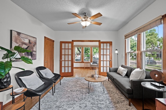 3608 Park Ave Unit 102, Minneapolis, MN 55407 - living area with french doors, wood finished floors, a textured ceiling, and a ceiling fan