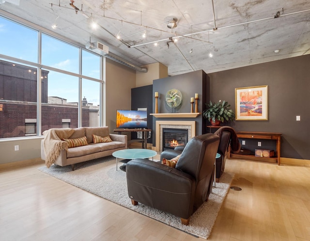 100 2nd St NE Unit A270, Minneapolis, MN 55413 - living area featuring wood finished floors, a glass covered fireplace, baseboards, and track lighting