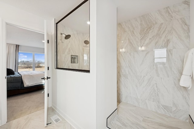 ensuite bathroom with walk in shower and marble look tiles