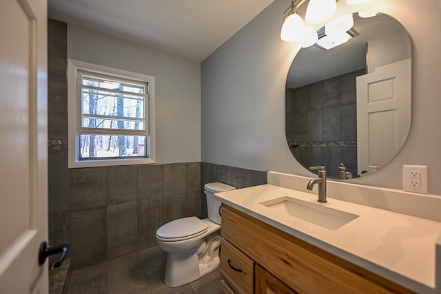 1192 Blackburn Rd, Scott Twp, WI 54801 - bathroom with tile walls, wainscoting, vanity, toilet, and tile patterned floors