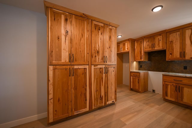 1192 Blackburn Rd, Scott Twp, WI 54801 - kitchen featuring brown cabinets, backsplash, light wood-style flooring, and recessed lighting