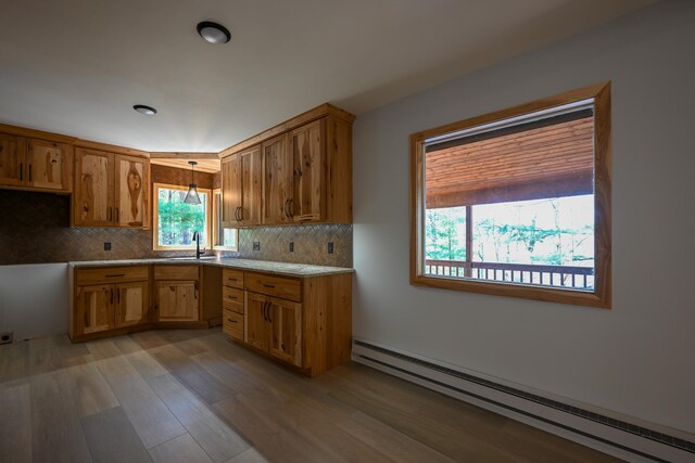 1192 Blackburn Rd, Scott Twp, WI 54801 - kitchen with a baseboard radiator, a sink, light wood finished floors, backsplash, and recessed lighting