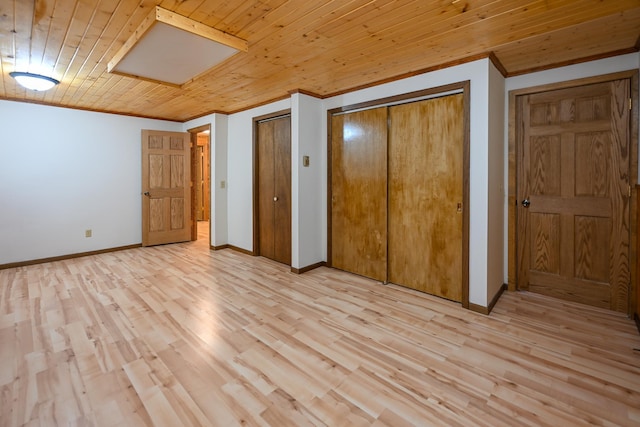 1192 Blackburn Rd, Scott Twp, WI 54801 - unfurnished bedroom with multiple closets, light wood finished floors, baseboards, crown molding, and wood ceiling