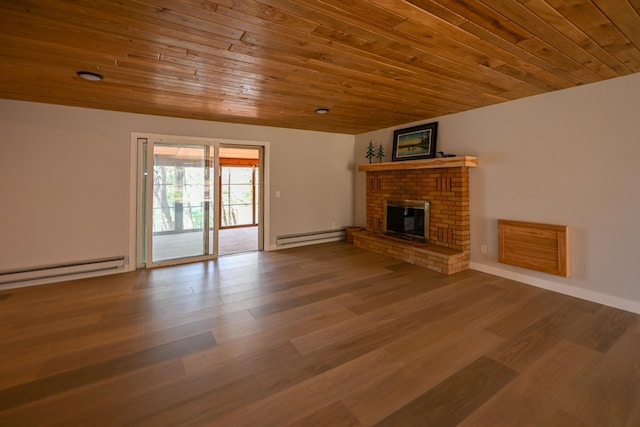 1192 Blackburn Rd, Scott Twp, WI 54801 - unfurnished living room featuring baseboard heating, wood ceiling, wood finished floors, and a brick fireplace