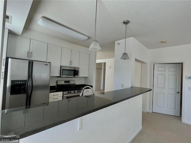 7601 Aldrich Ave S Unit 119, Richfield, MN 55423 - kitchen featuring stainless steel appliances, dark countertops, light carpet, decorative light fixtures, and baseboards