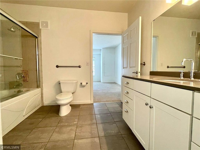 7601 Aldrich Ave S Unit 119, Richfield, MN 55423 - full bath featuring tile patterned floors, toilet, vanity, enclosed tub / shower combo, and baseboards