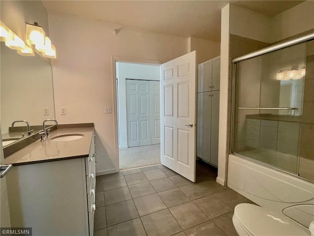 7601 Aldrich Ave S Unit 119, Richfield, MN 55423 - full bath with tile patterned floors, a chandelier, toilet, shower / bath combination with glass door, and vanity