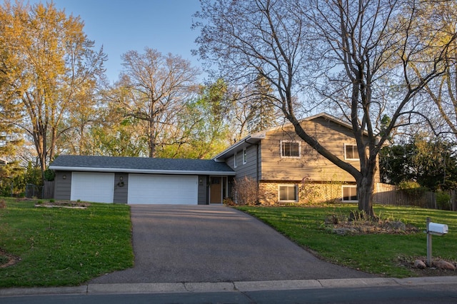 2241 17th St NW, New Brighton, MN 55112 - split level home with driveway, a front lawn, and an attached garage