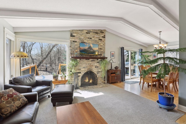 2241 17th St NW, New Brighton, MN 55112 - living area with lofted ceiling, a chandelier, plenty of natural light, a fireplace, and wood finished floors