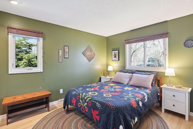 2241 17th St NW, New Brighton, MN 55112 - bedroom with wood finished floors and baseboards