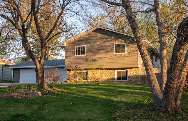 2241 17th St NW, New Brighton, MN 55112 - rear view of property featuring a yard, brick siding, concrete driveway, and an attached garage