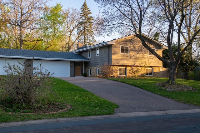 2241 17th St NW, New Brighton, MN 55112 - tri-level home featuring a garage, driveway, and a front lawn