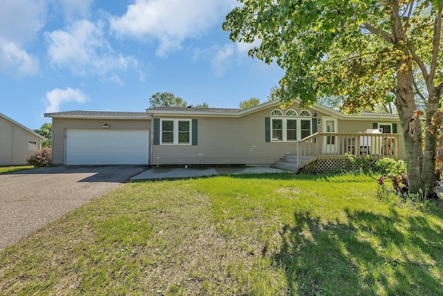 3209 3rd Ave NW, Willmar, MN 56201 - view of front of property with asphalt driveway, a garage, and a front lawn