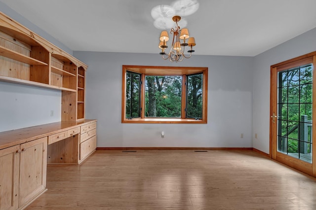 13047 Endicott Dr NW, Clearwater, MN 55320 - unfurnished dining area with a chandelier, light wood-type flooring, and baseboards