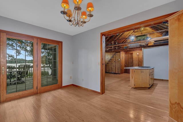 13047 Endicott Dr NW, Clearwater, MN 55320 - unfurnished dining area featuring light wood-type flooring, baseboards, and a chandelier