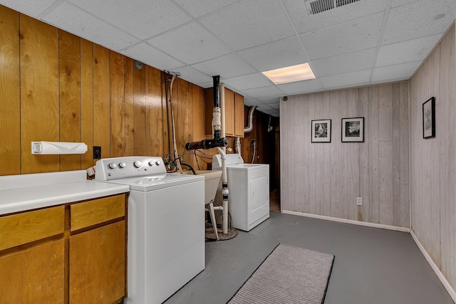 13047 Endicott Dr NW, Clearwater, MN 55320 - laundry area with separate washer and dryer, cabinet space, baseboards, and wooden walls