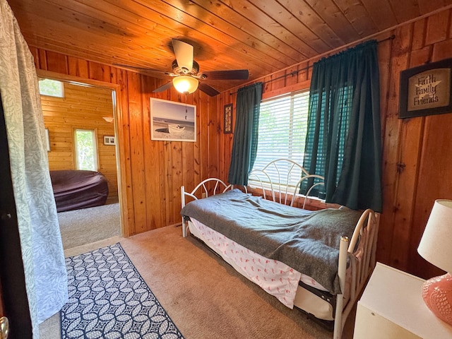 41443 County Highway 1, Ottertail, MN 56571 - bedroom with multiple windows, wood walls, wood ceiling, carpet flooring, and a ceiling fan