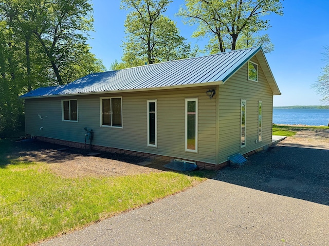 41443 County Highway 1, Ottertail, MN 56571 - view of home's exterior with a water view, a standing seam roof, and metal roof