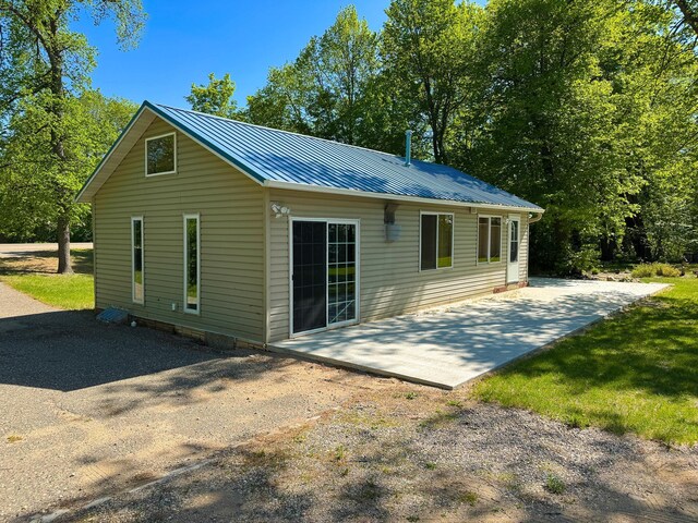 41443 County Highway 1, Ottertail, MN 56571 - rear view of house with a patio area and metal roof