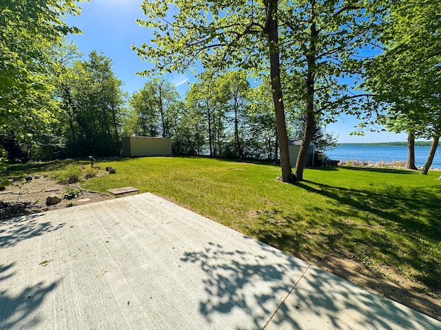 41443 County Highway 1, Ottertail, MN 56571 - view of grassy yard with a water view and a patio area