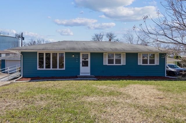 single story home with a front yard, entry steps, and a garage