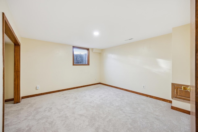 basement featuring carpet flooring and baseboards