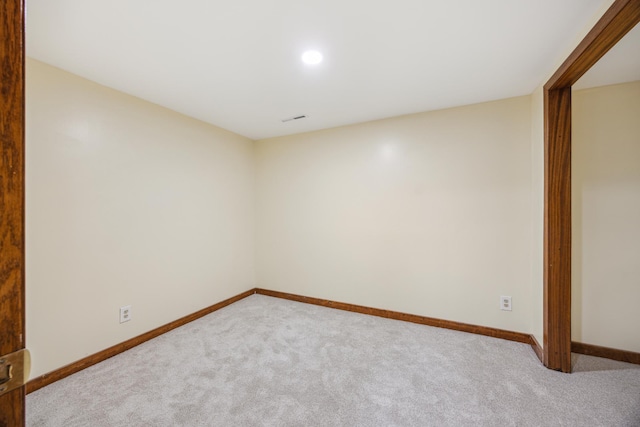 carpeted empty room featuring baseboards and recessed lighting