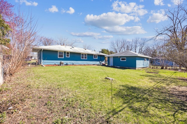 back of house featuring a lawn