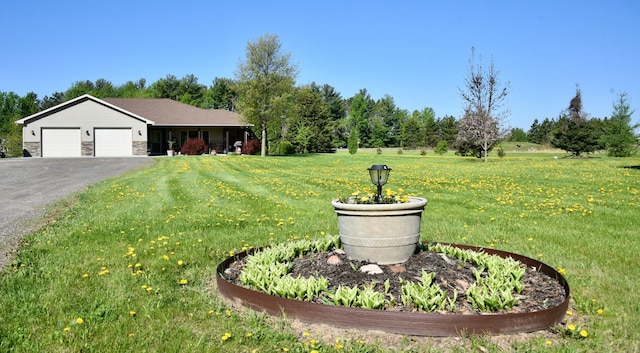 11375 Gem St, Milaca, MN 56353 - view of grassy yard with a garage and driveway