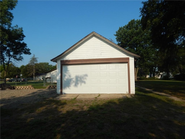 detached garage featuring fence