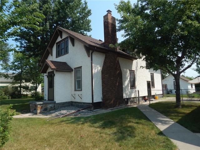view of property exterior featuring a chimney and stucco siding