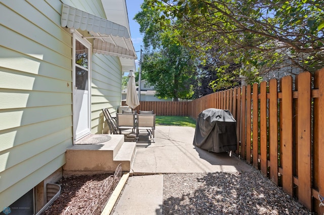 2807 Edgewood Dr N, Fargo, ND 58102 - view of patio featuring outdoor dining area, a fenced backyard, and grilling area