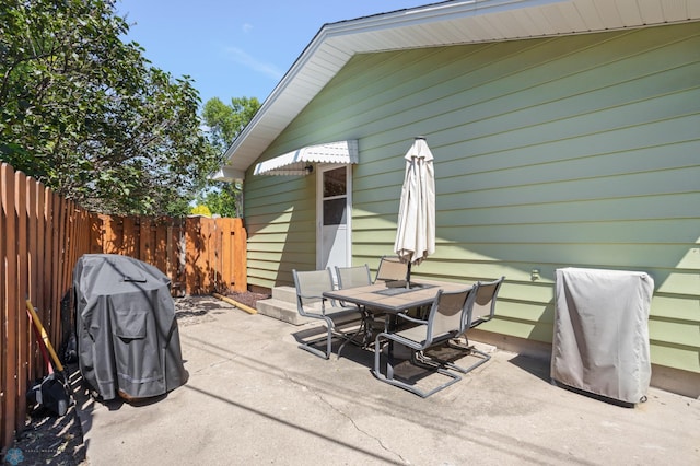 2807 Edgewood Dr N, Fargo, ND 58102 - view of patio featuring outdoor dining space, fence, and grilling area