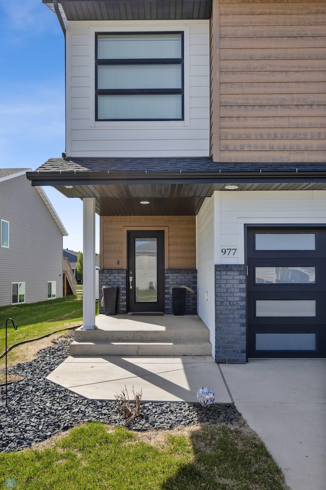 977 Ashley Dr W, West Fargo, ND 58078 - property entrance with a porch, stone siding, and a lawn