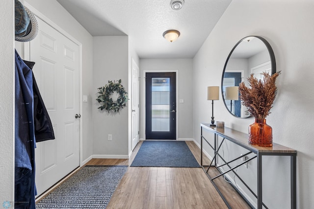 977 Ashley Dr W, West Fargo, ND 58078 - entrance foyer featuring wood finished floors, baseboards, and a textured ceiling