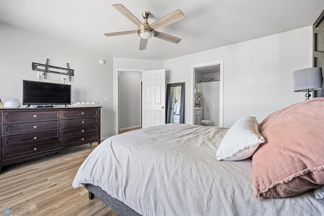 977 Ashley Dr W, West Fargo, ND 58078 - bedroom with wood finished floors, connected bathroom, and ceiling fan