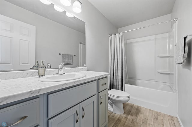 977 Ashley Dr W, West Fargo, ND 58078 - bathroom featuring toilet, wood finished floors, vanity, and shower / bathtub combination with curtain