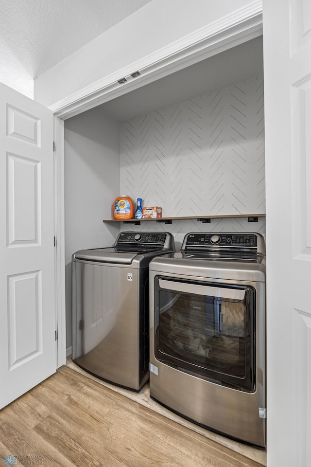 977 Ashley Dr W, West Fargo, ND 58078 - laundry room featuring washing machine and clothes dryer and light wood-style floors