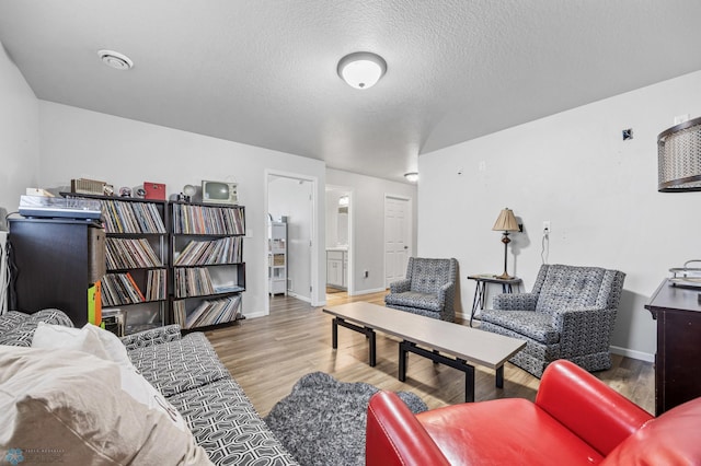 977 Ashley Dr W, West Fargo, ND 58078 - living area featuring wood finished floors, a textured ceiling, and baseboards