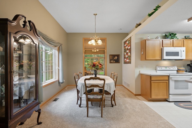 19136 Concord Ct NW, Elk River, MN 55330 - dining area featuring a chandelier, baseboards, and light carpet
