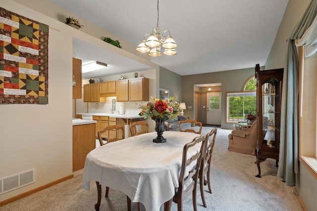 19136 Concord Ct NW, Elk River, MN 55330 - dining area with light colored carpet, a chandelier, and baseboards