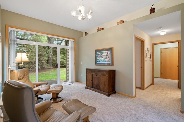 19136 Concord Ct NW, Elk River, MN 55330 - living area featuring light carpet, a chandelier, and baseboards