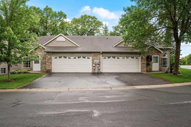 19136 Concord Ct NW, Elk River, MN 55330 - view of front facade with asphalt driveway, brick siding, a garage, and roof with shingles