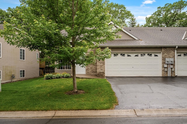 19136 Concord Ct NW, Elk River, MN 55330 - view of front of home featuring brick siding, a shingled roof, a front lawn, driveway, and an attached garage