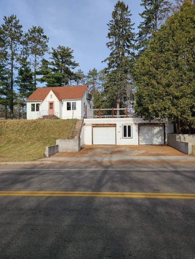 103 4th St, Grand Rapids, MN 55744 - view of front of home with a garage and driveway