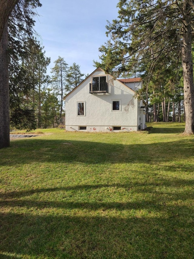 103 4th St, Grand Rapids, MN 55744 - view of side of home featuring a lawn
