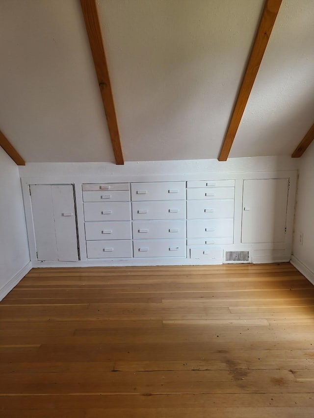 103 4th St, Grand Rapids, MN 55744 - additional living space with wood finished floors, mail area, and baseboards