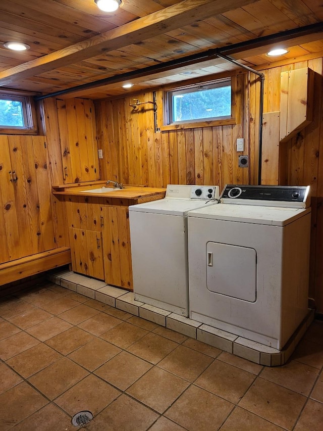 103 4th St, Grand Rapids, MN 55744 - laundry area with wooden ceiling, wooden walls, light tile patterned floors, and washing machine and dryer