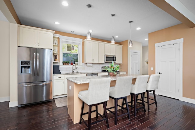 1013 Planters Path, Bayport, MN 55003 - kitchen with stainless steel appliances, a sink, dark wood finished floors, a kitchen island, and recessed lighting