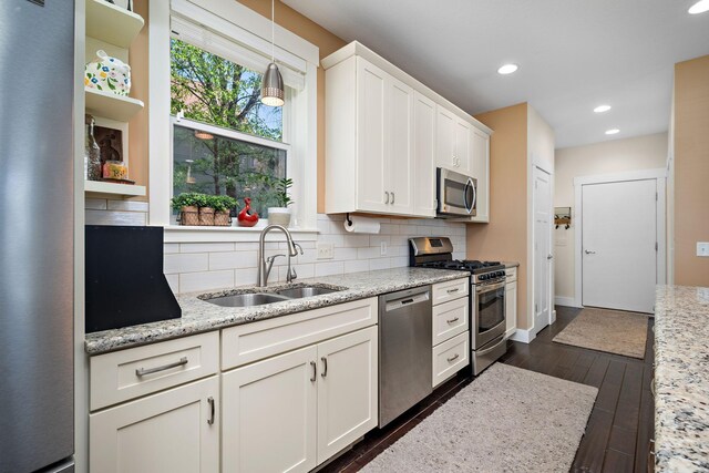1013 Planters Path, Bayport, MN 55003 - kitchen with stainless steel appliances, a sink, open shelves, tasteful backsplash, and white cabinets